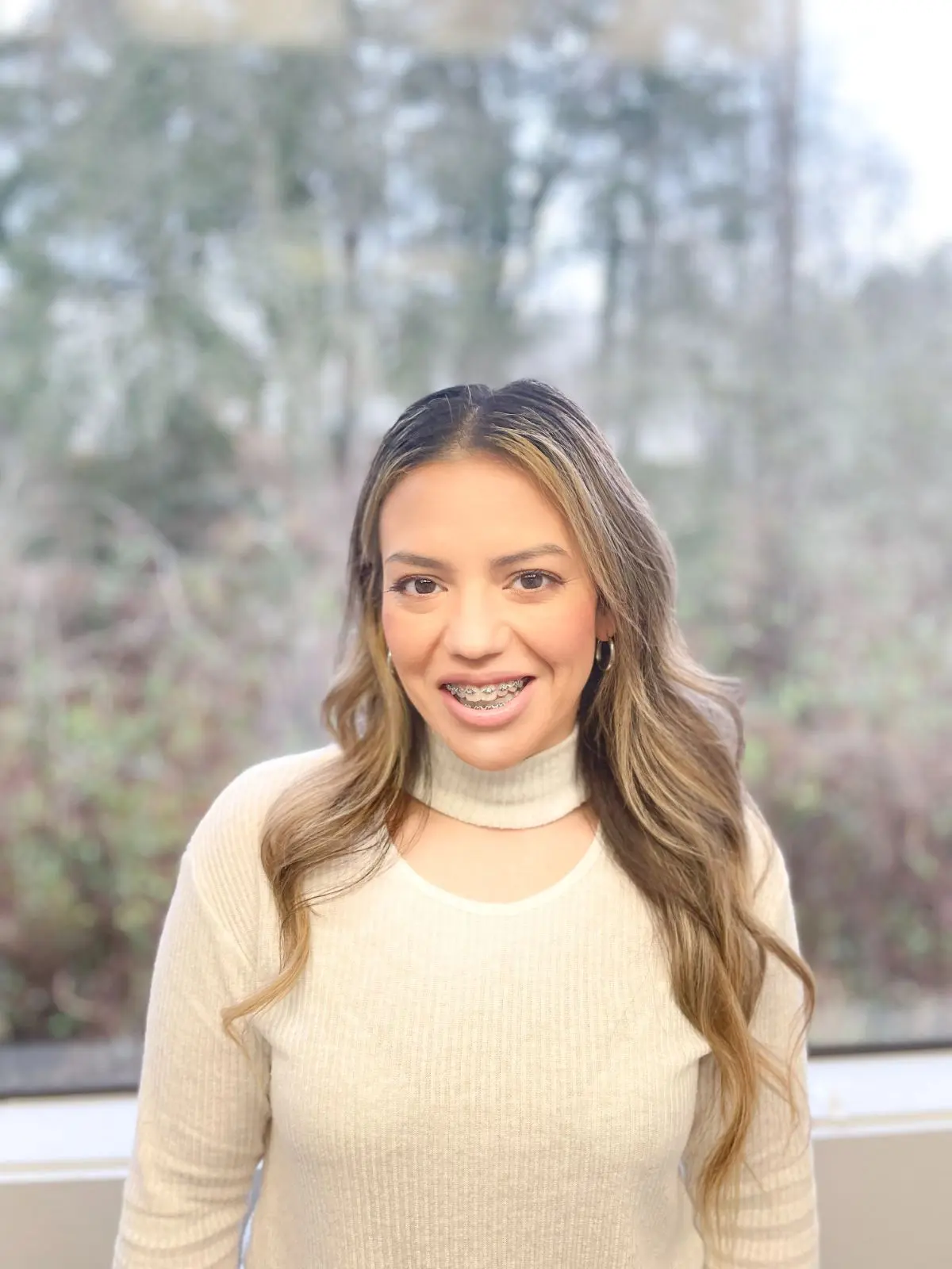 A portrait of a woman with metal braces, after a Personalized Top-Rated Kent, WA Orthodontic Treatment