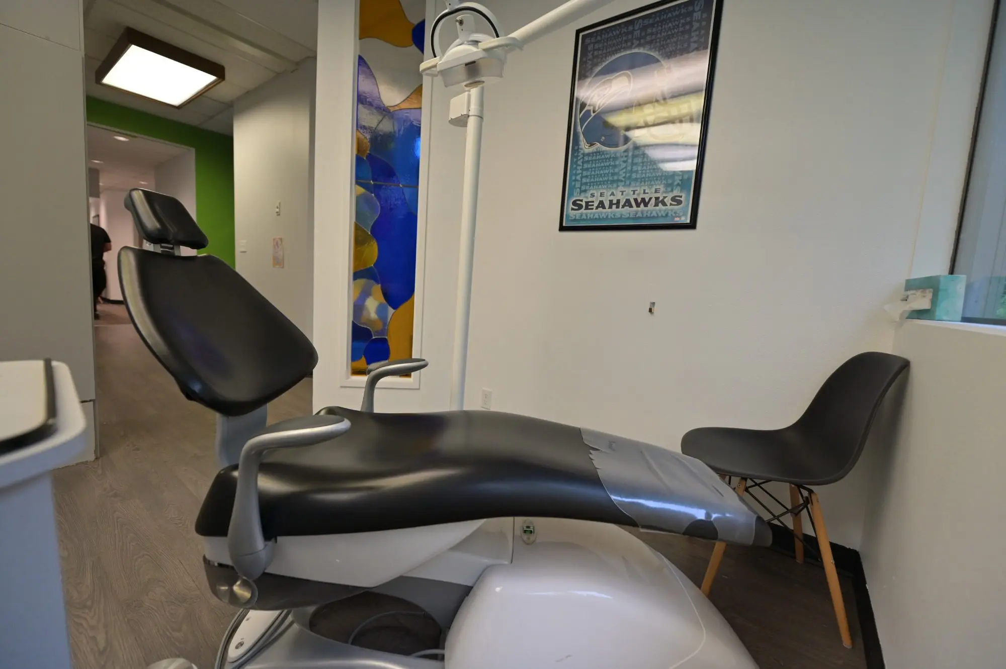 Orthodontic expert's exam room featuring a reclining chair, informative wall poster, and a cozy side chair in
Kent or Sammamish, WA