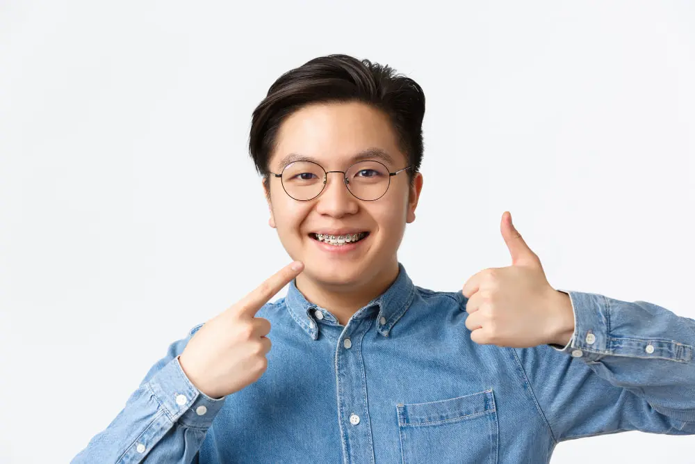 An adult showing his braces in Sammamish and Kent, WA
